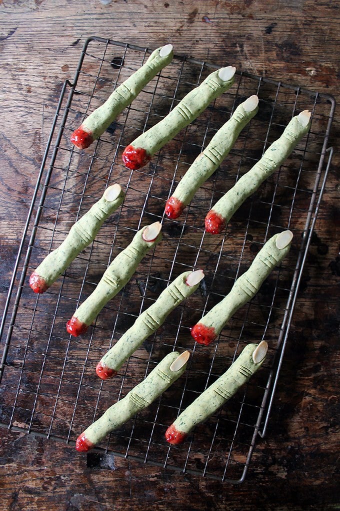 Rows of green witch fingers - cookies made from spinach (can't taste it!) to make them green, almond slivers for fingernails and jam at the bottom to show them as severed fingers. 