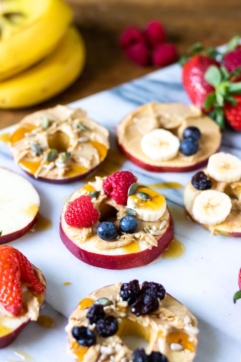 Apple pizzas. This healthy snack is really easy. Slices of apple are spread with peanut butter and topped with fruit and seeds, with a little drizzle of maple syrup. Get the heathy snack recipe now. 